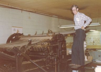 Wilber Brett on printing press. Wilber Brett on printing press.
